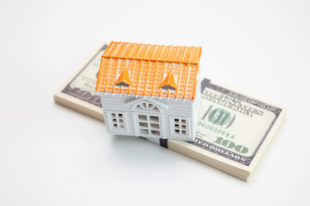 Model house is placed on the US dollar banknotes
